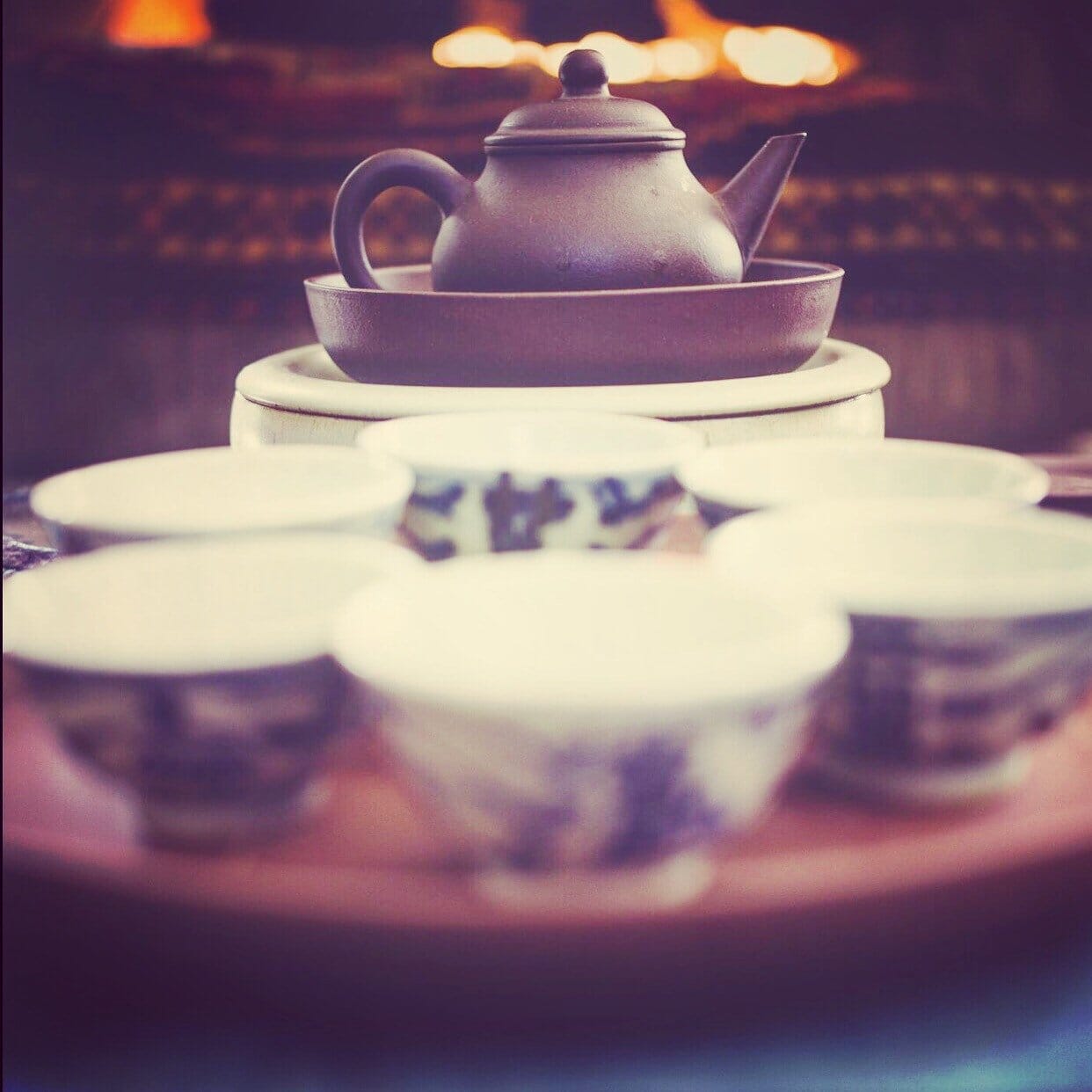 Teapot Surrounded by teacups 